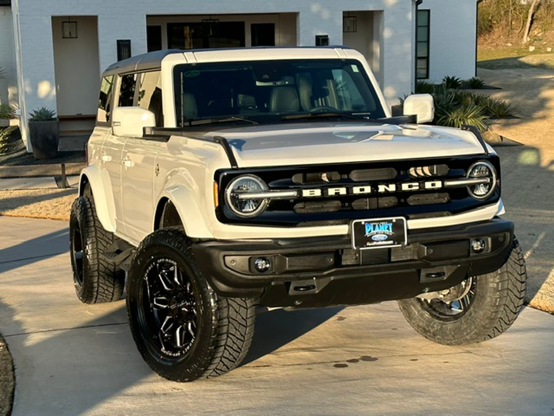 Lifted Ford Bronco with finished wheel and tire stance